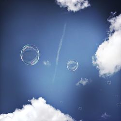 Low angle view of bubbles against sky