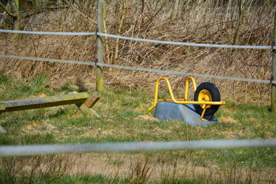 Upside down wheelbarrow on grassy field