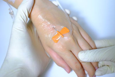 Cropped hands of doctor injecting patient in hospital