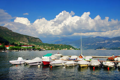 Boats moored in lake against landscape