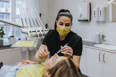 Female dentist with patient in dentist's office