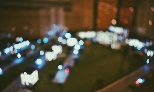 Defocused image of illuminated city at night