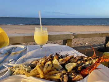 Close-up of food on sea against sky