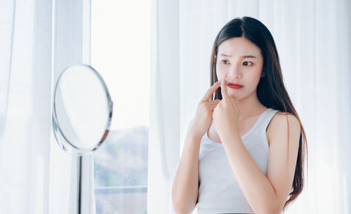 Portrait of a young woman making face