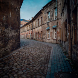 Empty alley amidst buildings in city