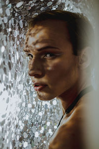 Close-up portrait of shirtless man looking away