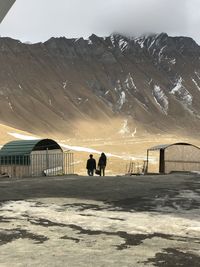 People on snowcapped mountain against sky travel 