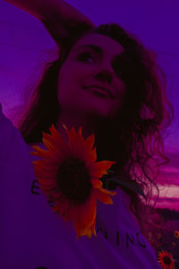 Portrait of beautiful woman with red flower