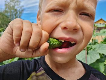 Boy cleans weeds in the garden