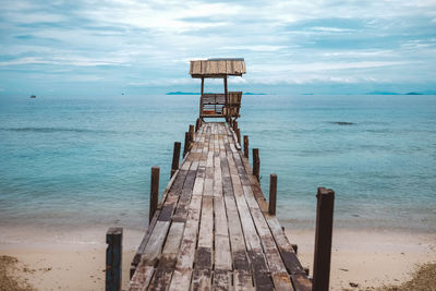 Lifeguard hut at beach against sky