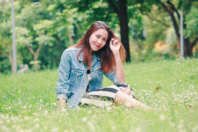 Portrait of beautiful young woman in grass