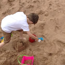 High angle view of boy playing with toy on beach