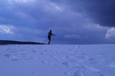 Man skiing on snow against sky