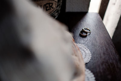 Selective focus of wedding rings on wood