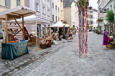 People on street amidst buildings in city