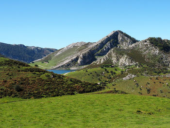 Scenic view of mountains against clear blue sky