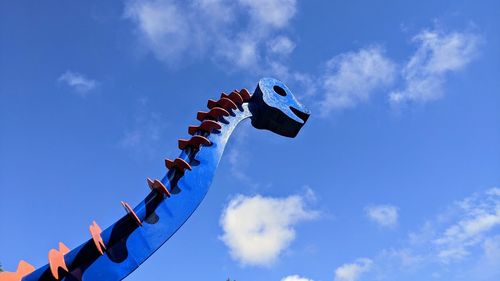 Low angle view of airplane flying against blue sky