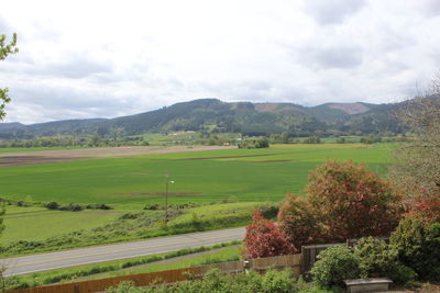 Scenic view of landscape against cloudy sky
