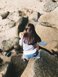 Rear view of woman on rock