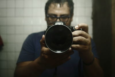 Close-up of man holding camera