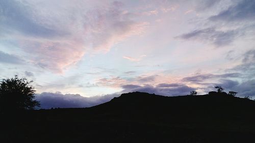 Scenic view of mountains against cloudy sky