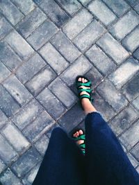 Low section of woman standing on tiled floor