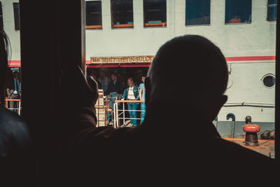 Rear view of silhouette man standing in restaurant