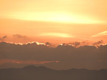 Scenic view of silhouette mountains against sky during sunset