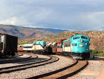 View of trains against cloudy sky