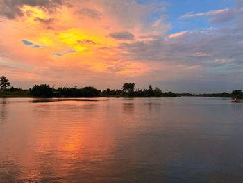 Scenic view of lake against orange sky