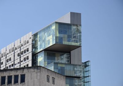 Low angle view of modern building against clear blue sky