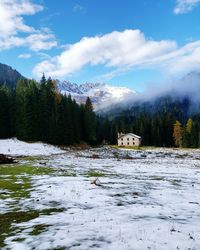 Scenic view of mountains against cloudy sky