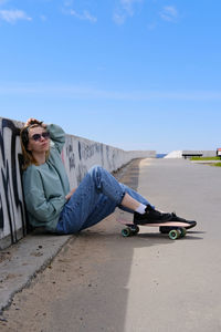 Low angle view of people on road against sky