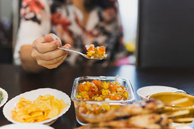 Homemade tomato sauce salsa dip with nachos on table.