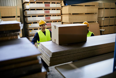 Two workers in factory warehouse