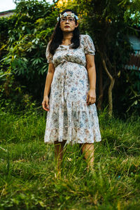 Portrait of woman standing on field