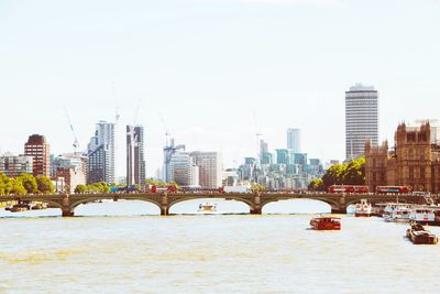 Bridge over river with city in background