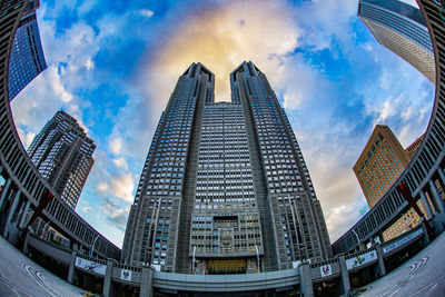 Low angle view of buildings against cloudy sky