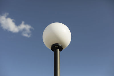 Low angle view of street light against blue sky