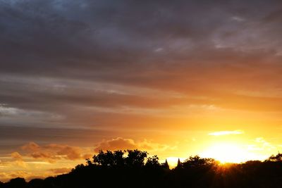 Silhouette trees against sky during sunset