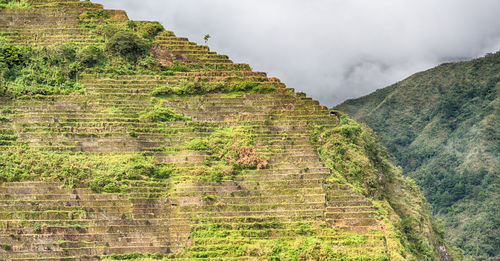 Scenic view of mountain against cloudy sky