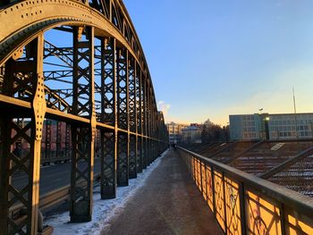 Bridge in city against clear sky