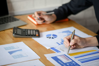 High angle view of man using mobile phone on table