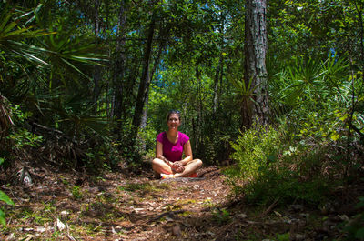 Woman sitting in a forest