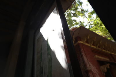 Low angle view of building seen through window