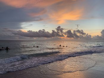 Scenic view of beach against sky during sunset