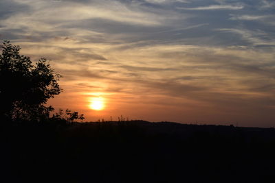 Scenic view of silhouette landscape against romantic sky at sunset