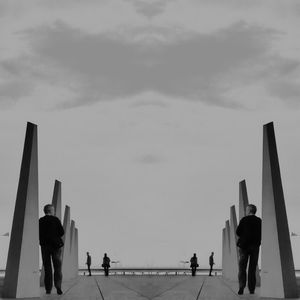 Rear view of silhouette people walking against sky