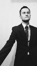 Portrait of a smiling man standing against white background