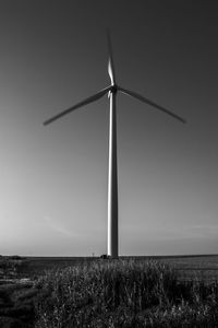 Windmill on field against sky